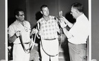Humble employees examine new pocket-size slings to replace steel cable in rigging, 1966