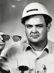 Line crewman Floyd Barron displays safety glasses, 1966