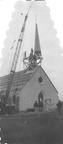 Steeple being mounted onto First Methodist Church in Pelly, 1949.