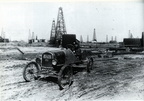An unidentified man with his car in the middle of the Goose Creek oil field